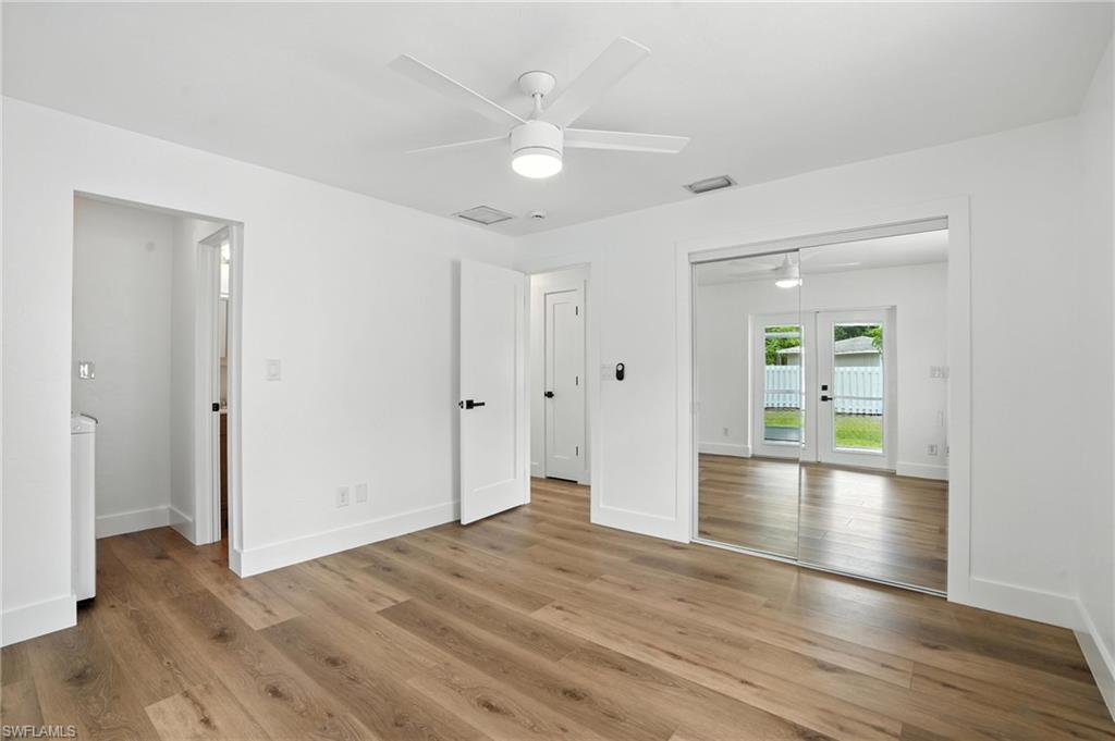 1336 Highlands Drive Naples, FL 34103 - Photo 5 of 17 a view of empty room with wooden floor and window