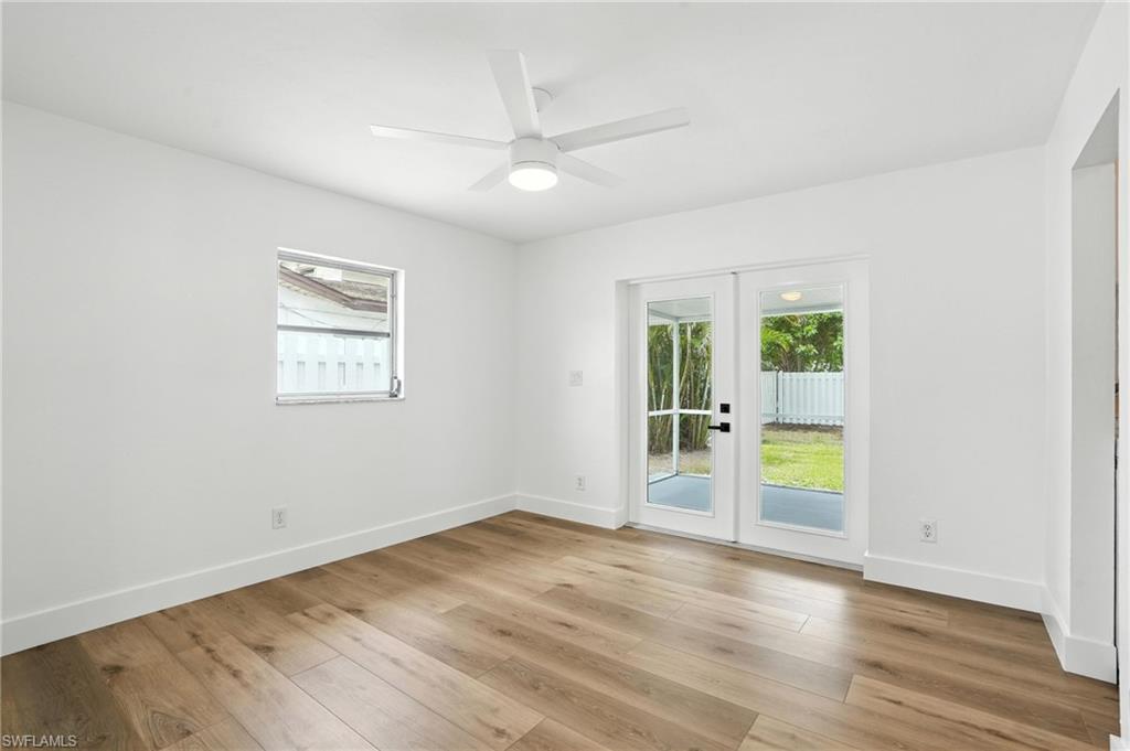1336 Highlands Drive Naples, FL 34103 - Photo 6 of 17 an empty room with wooden floor and windows