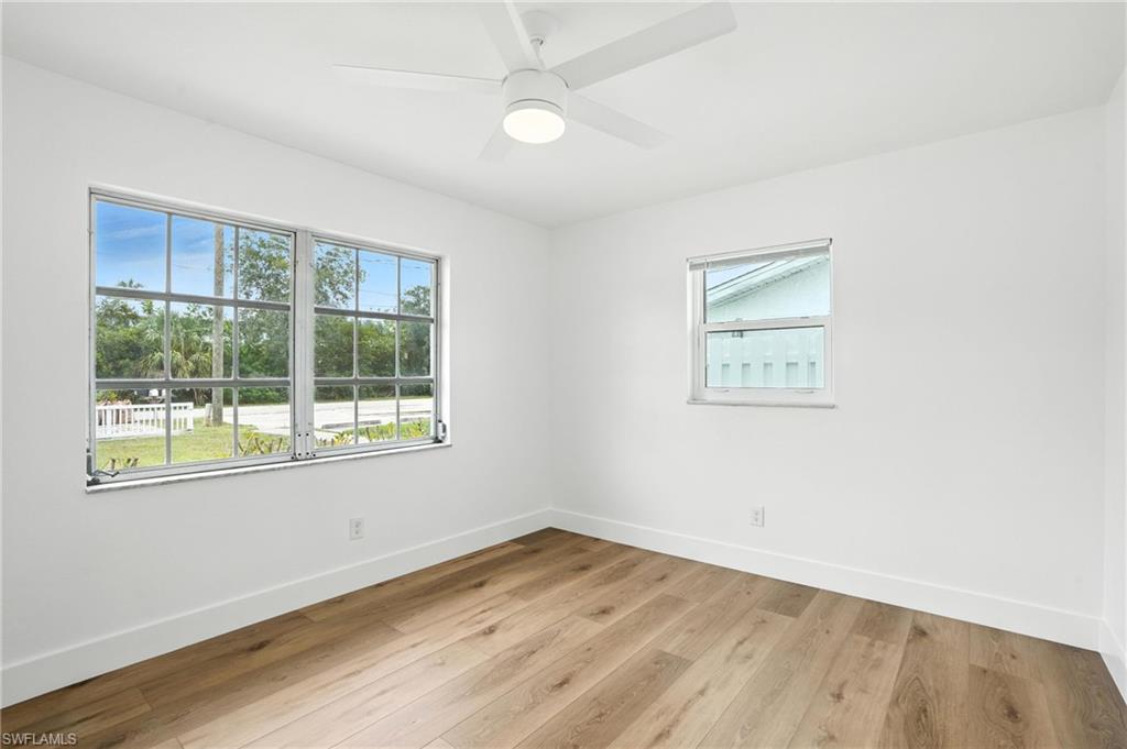 1336 Highlands Drive Naples, FL 34103 - Photo 10 of 17 an empty room with wooden floor and windows