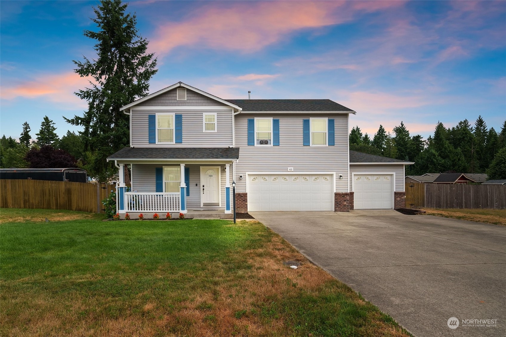 a view of a house with a yard and deck