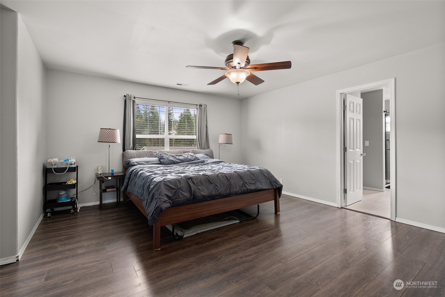 413 Easy Street Rainier, WA 98576 - Photo 14 of 30 a spacious bedroom with a bed and wooden floor