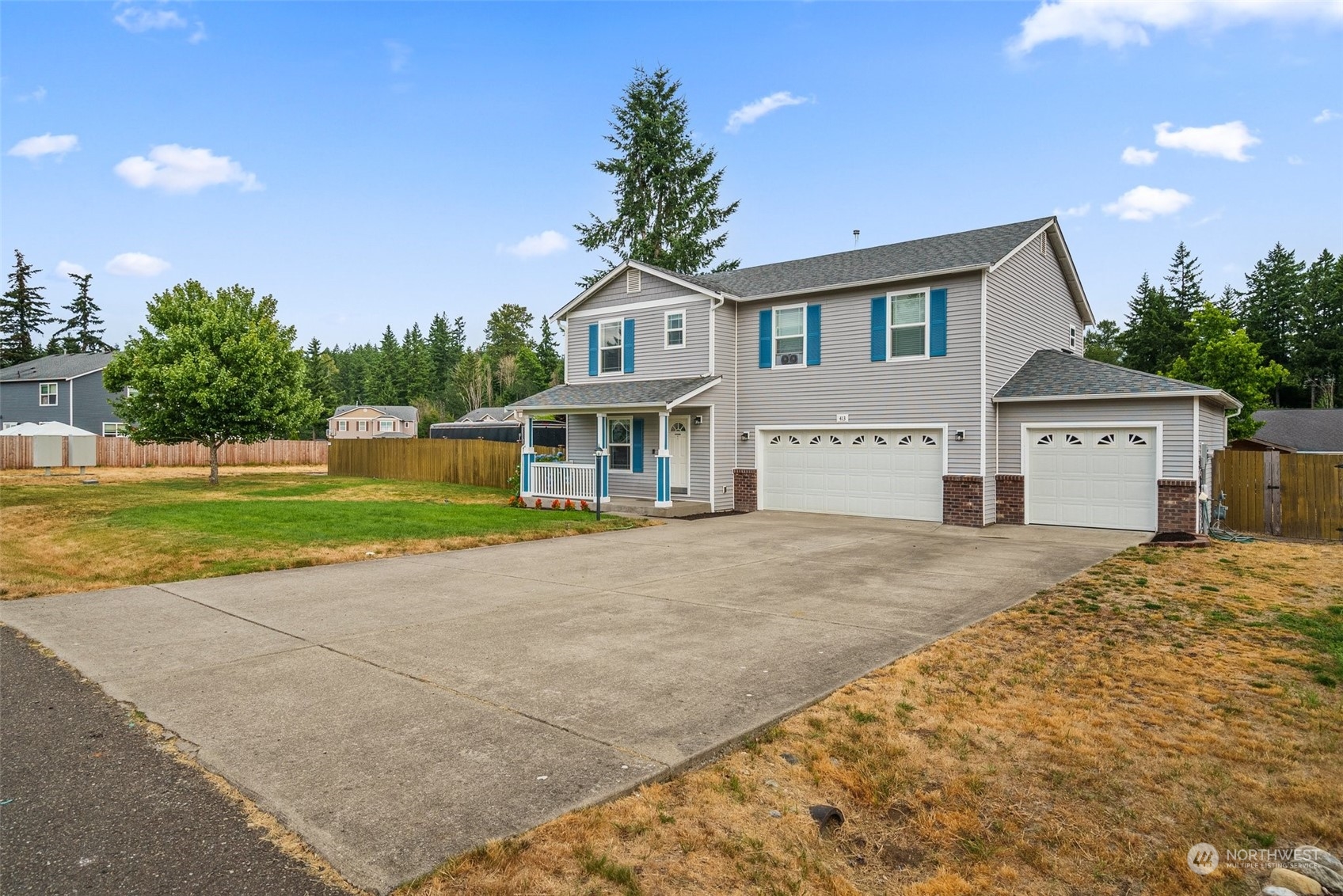 413 Easy Street Rainier, WA 98576 - Photo 3 of 30 a front view of a house with a yard and garage
