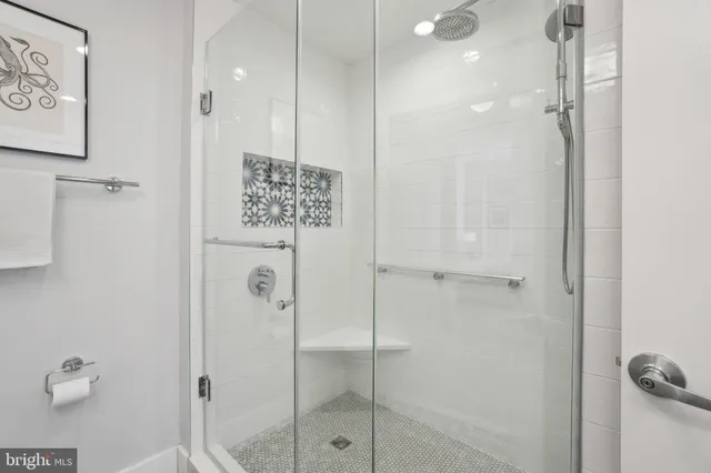 a bathroom with a sink a toilet a shower and a mirror