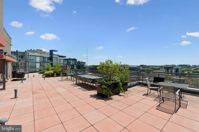 a view of a patio with table and chairs