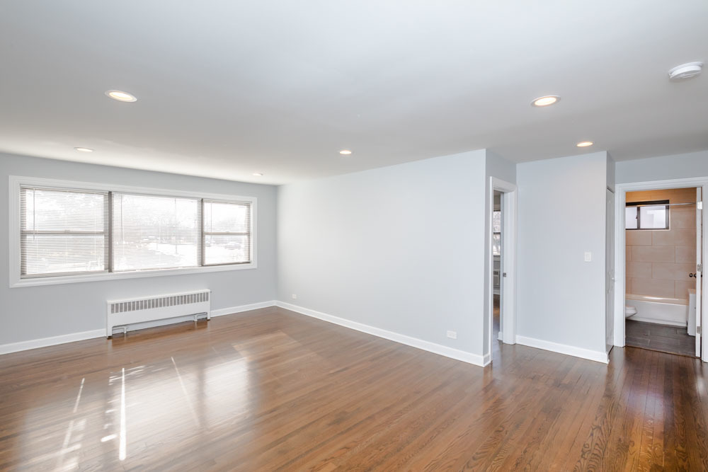 6807 North Ridge Boulevard, Unit 101 Chicago, IL 60645 - Photo 13 of 13 an empty room with wooden floor and windows