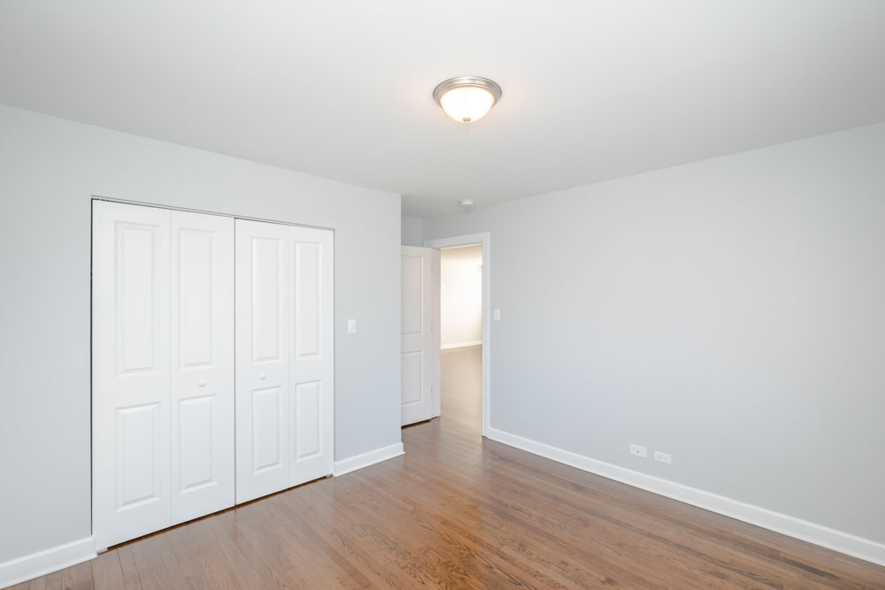 6807 North Ridge Boulevard, Unit 101 Chicago, IL 60645 - Photo 4 of 13 a view of an empty room with wooden floor