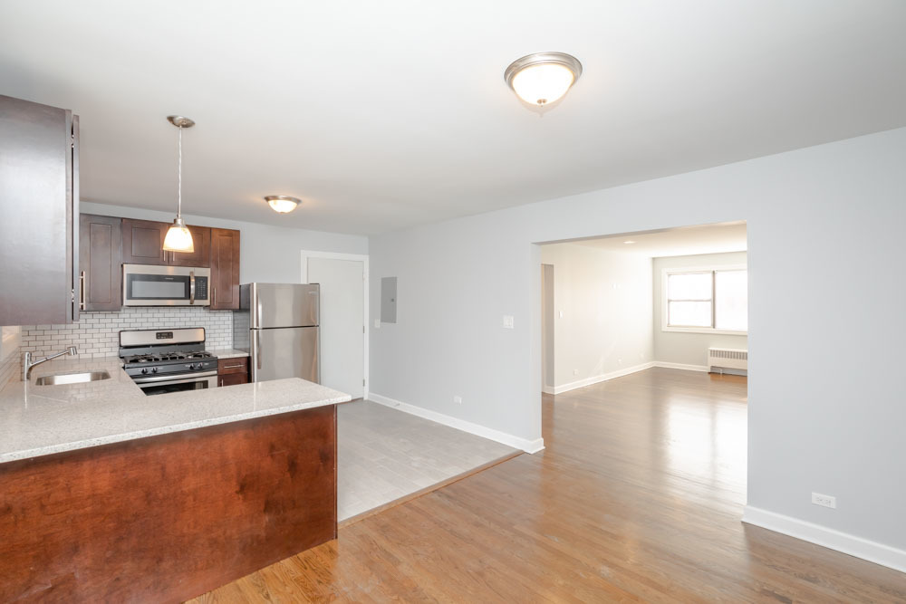 6807 North Ridge Boulevard, Unit 101 Chicago, IL 60645 - Photo 9 of 13 a kitchen with stainless steel appliances a refrigerator and a stove top oven