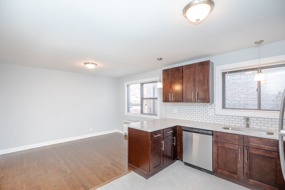 6807 North Ridge Boulevard, Unit 101 Chicago, IL 60645 - Photo 10 of 13 a kitchen with granite countertop a sink and a stove