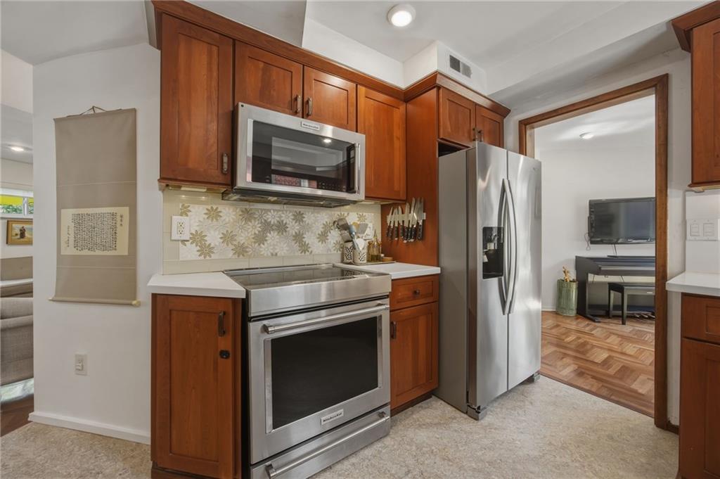 5535 Forbes Avenue, Unit E Pittsburgh, PA 15217 - Photo 13 of 50 a kitchen with stainless steel appliances granite countertop a refrigerator stove and microwave