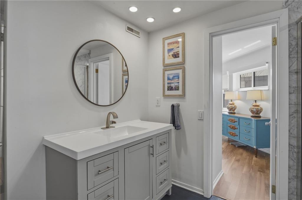 5535 Forbes Avenue, Unit E Pittsburgh, PA 15217 - Photo 16 of 50 a bathroom with a sink and a mirror
