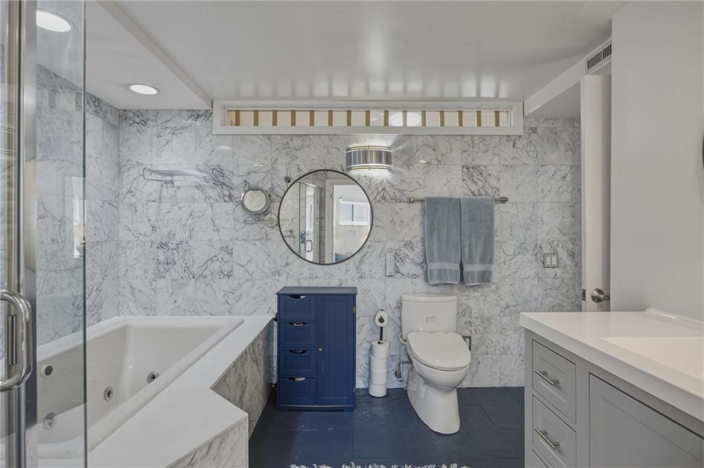 5535 Forbes Avenue, Unit E Pittsburgh, PA 15217 - Photo 17 of 50 a bathroom with a granite countertop toilet a sink and a mirror