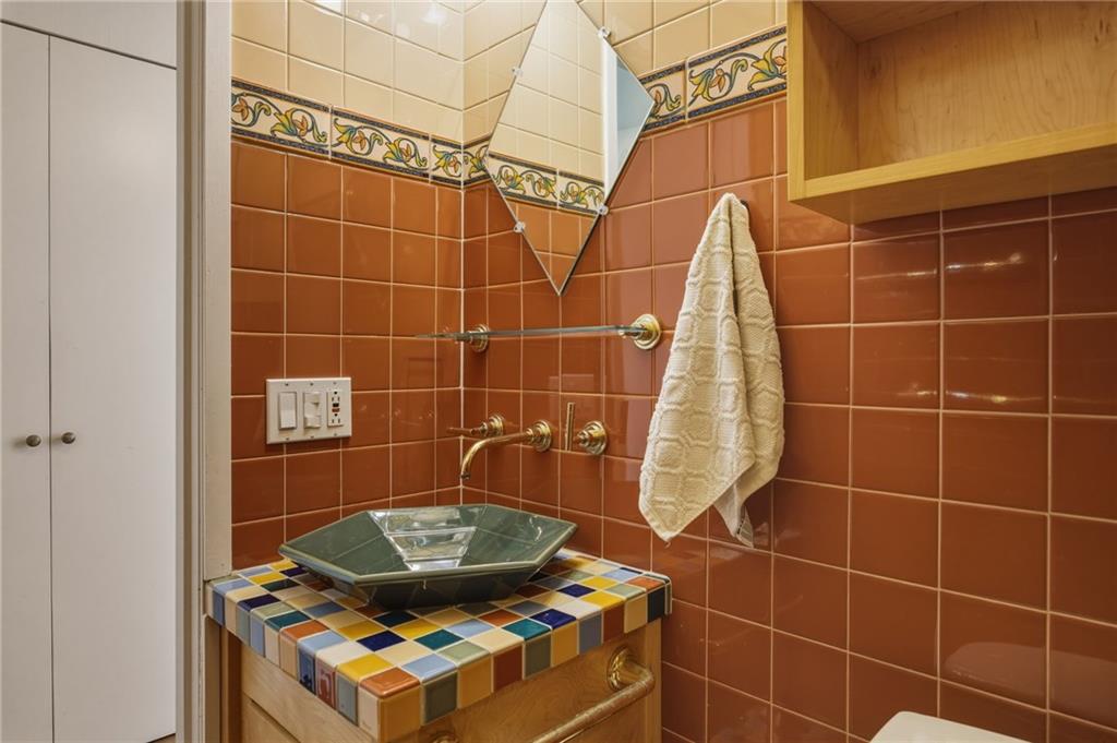 5535 Forbes Avenue, Unit E Pittsburgh, PA 15217 - Photo 22 of 50 a bathroom with a sink toilet shower and a mirror