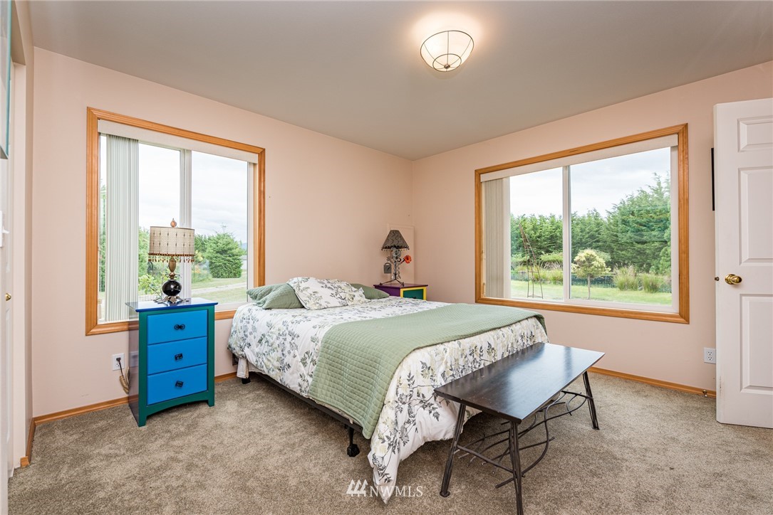 139 Buckhorn Road Sequim, WA 98382 - Photo 19 of 29 a bed sitting in a bedroom next to a window