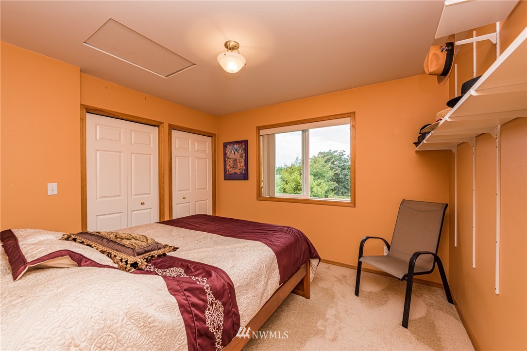 139 Buckhorn Road Sequim, WA 98382 - Photo 20 of 29 a bedroom with a bed and a window