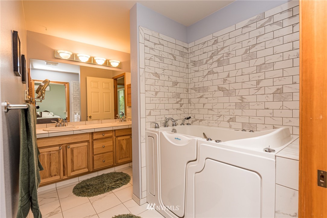 139 Buckhorn Road Sequim, WA 98382 - Photo 25 of 29 a bathroom with a sink a toilet and mirror