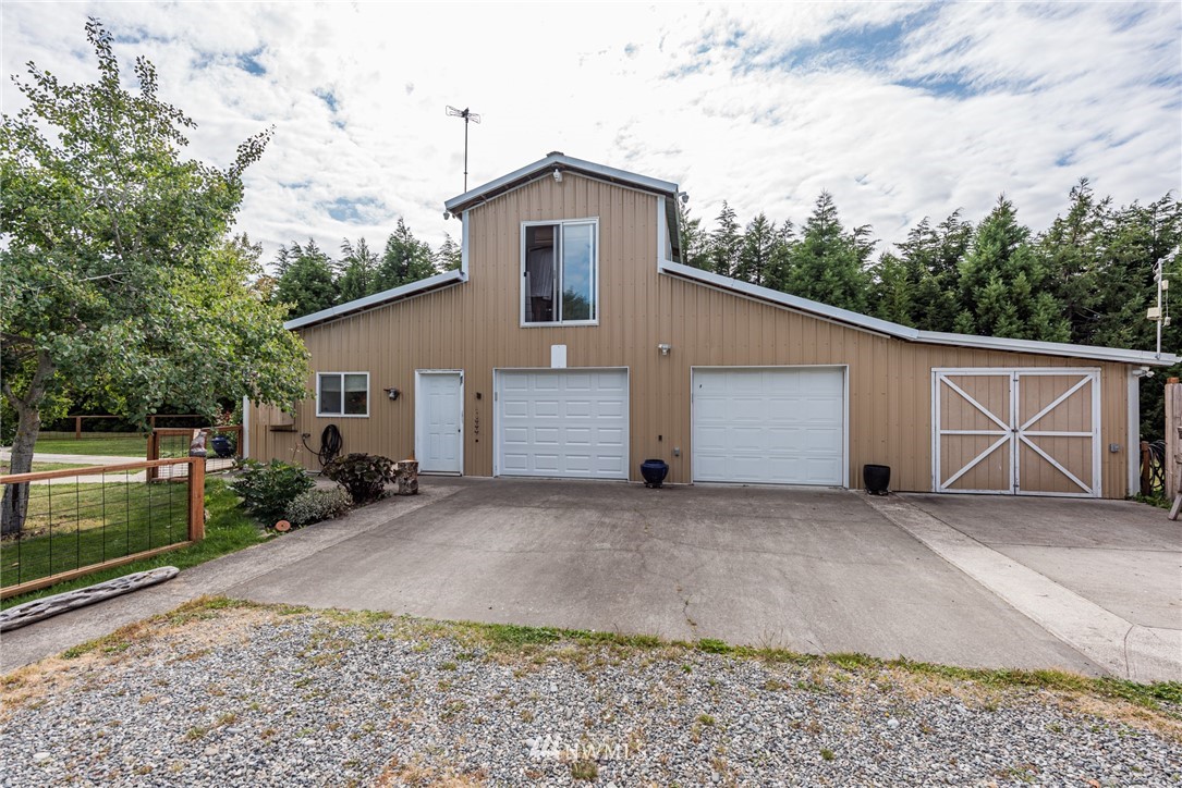 139 Buckhorn Road Sequim, WA 98382 - Photo 7 of 29 a view of a house with a backyard and garage