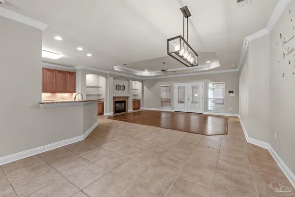 a view of an empty room and kitchen view