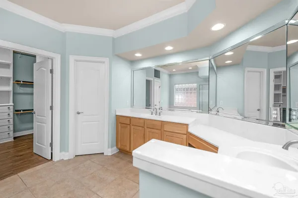 a large bathroom with a large tub and sink