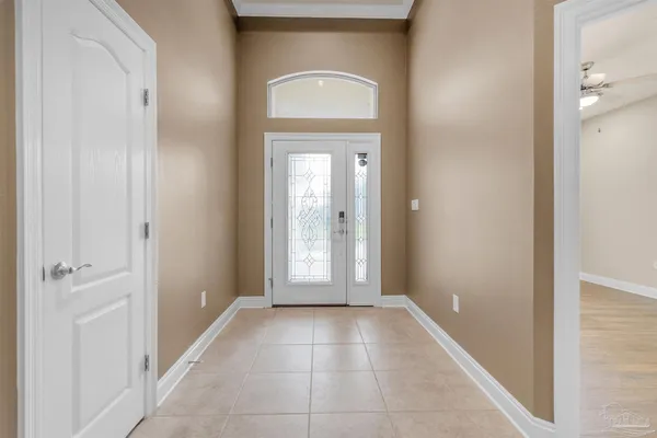 a view of a hallway with a glass door and a window
