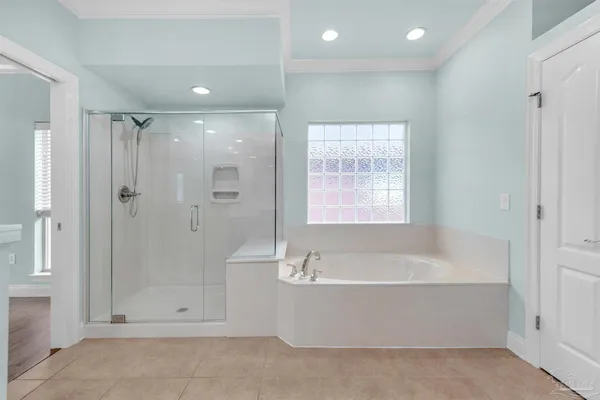 a bathroom with a bathtub a shower and a sink