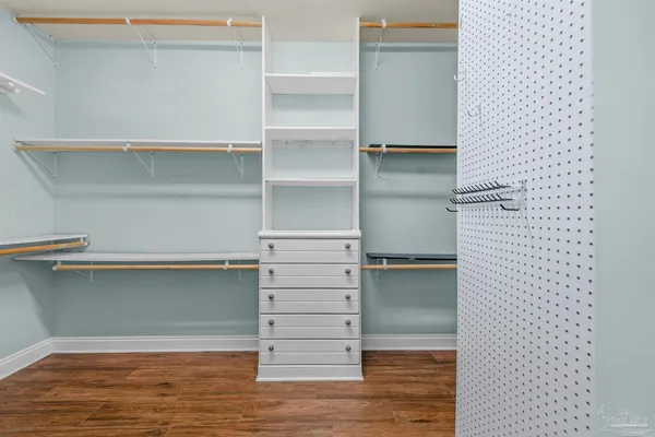 a view of walk in closet with empty racks
