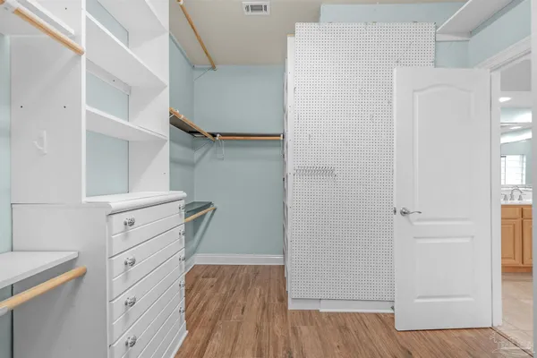 a view of walk in closet with empty racks