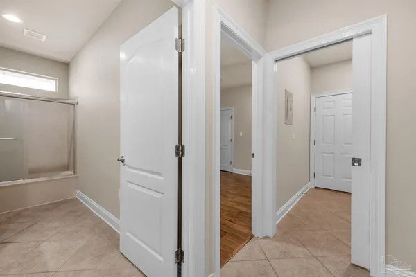a view of a hallway with an door and shower