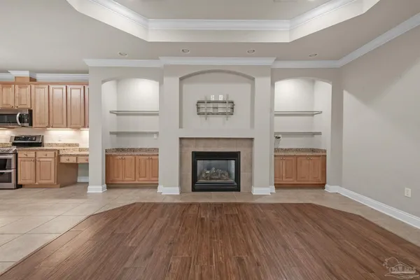 a living room with stainless steel appliances and a fireplace