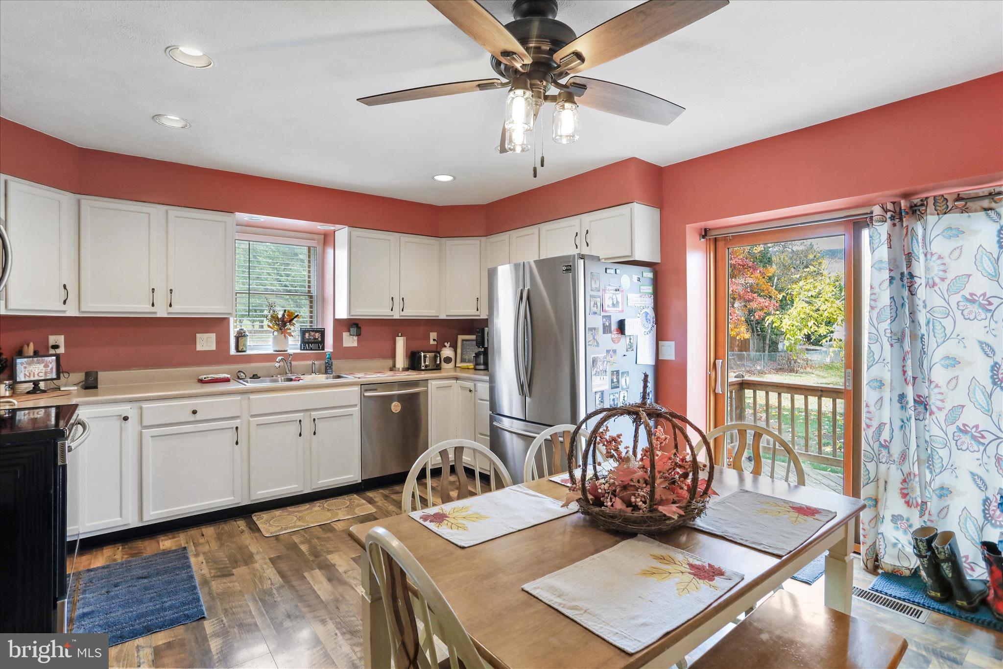 13719 Brant Road Southwest Cresaptown, MD 21502 - Photo 9 of 33 a kitchen with refrigerator a stove a sink dishwasher a dining table and chairs with wooden floor