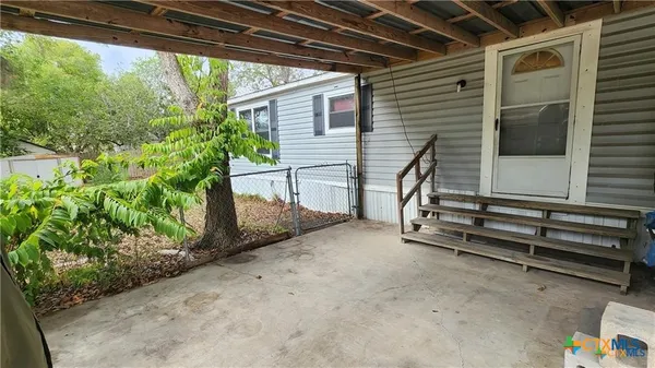 a view of a house with yard and a tree