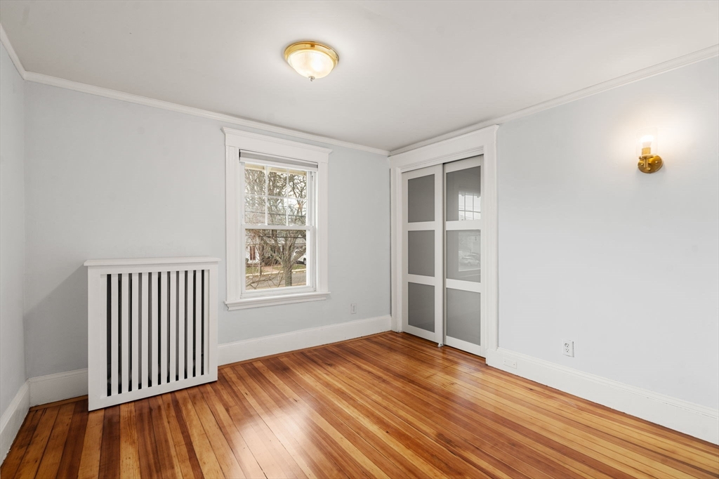 312 Edge Hill Road Milton, MA 02186 - Photo 13 of 19 an empty room with wooden floor and windows