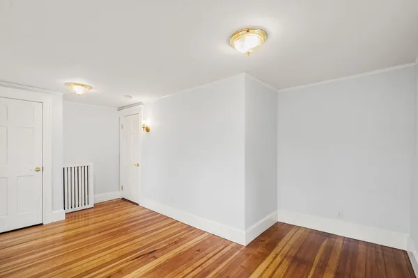 a view of a room with wooden floor and a sink