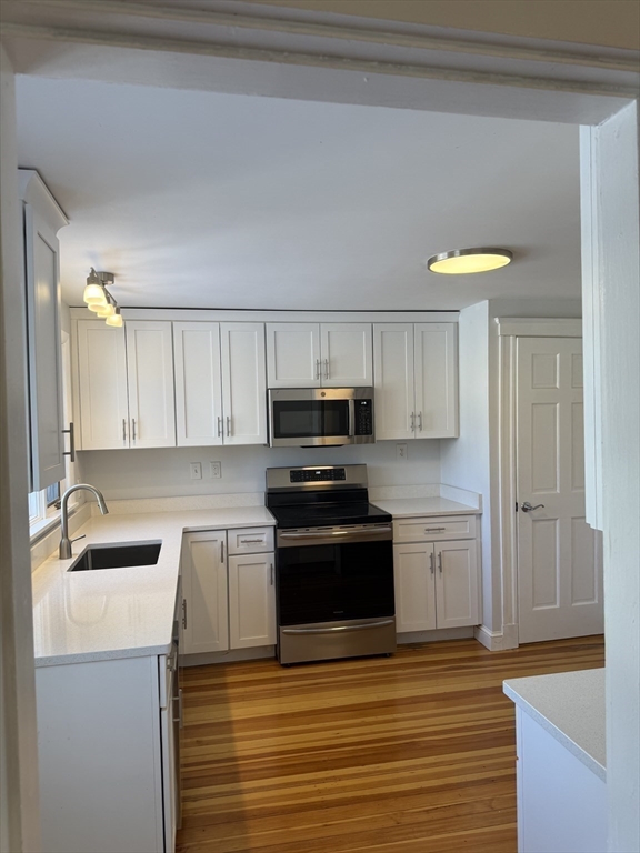 312 Edge Hill Road Milton, MA 02186 - Photo 2 of 13 a kitchen with granite countertop a sink cabinets and stainless steel appliances