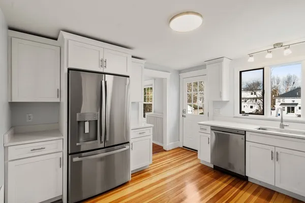 a kitchen with stainless steel appliances a refrigerator sink and cabinets