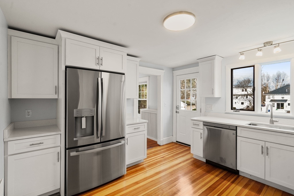 312 Edge Hill Road Milton, MA 02186 - Photo 6 of 19 a kitchen with stainless steel appliances a refrigerator sink and cabinets
