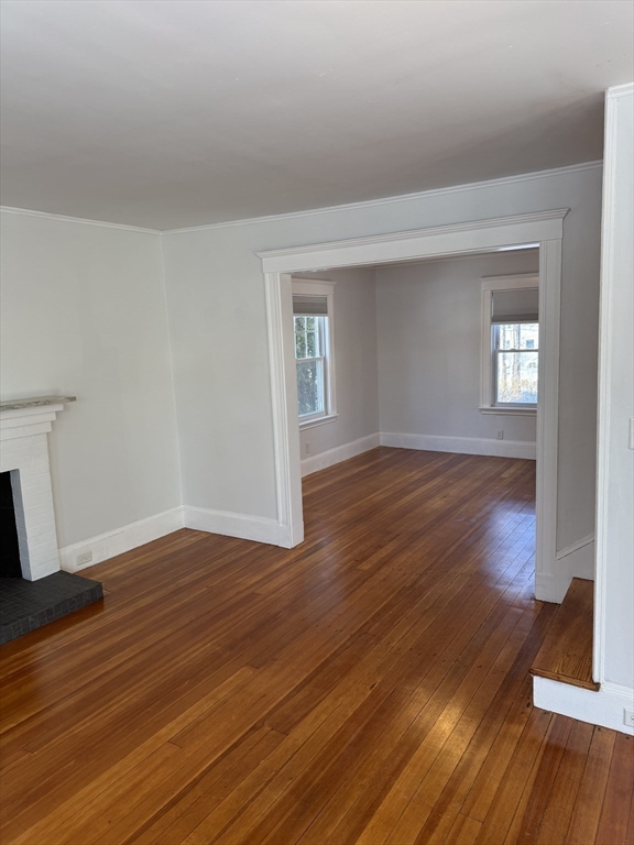 312 Edge Hill Road Milton, MA 02186 - Photo 7 of 13 a view of an empty room with wooden floor and a window