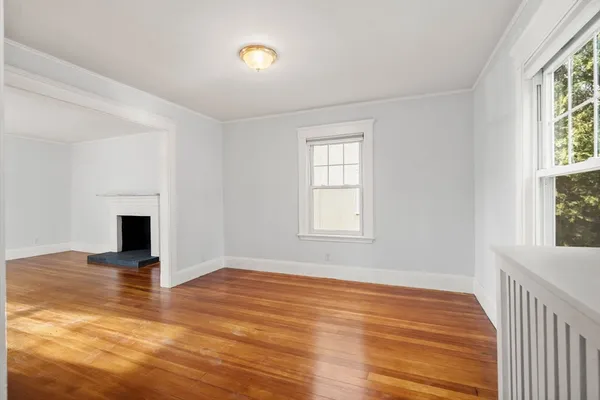 wooden floor in an empty room with a window