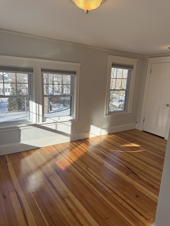 312 Edge Hill Road Milton, MA 02186 - Photo 9 of 13 a view of a room with wooden floor and a window