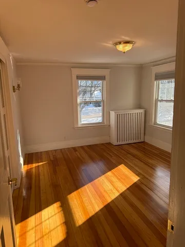 a view of a room with wooden floor and chair