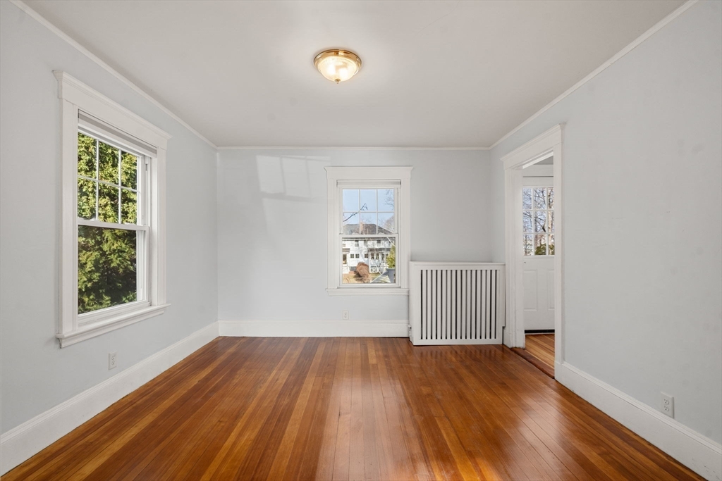 312 Edge Hill Road Milton, MA 02186 - Photo 10 of 19 a view of empty room with wooden floor and fan