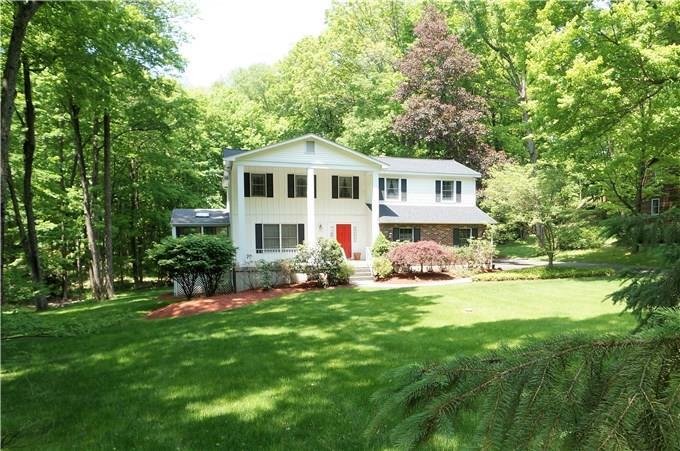 a front view of house with yard and green space