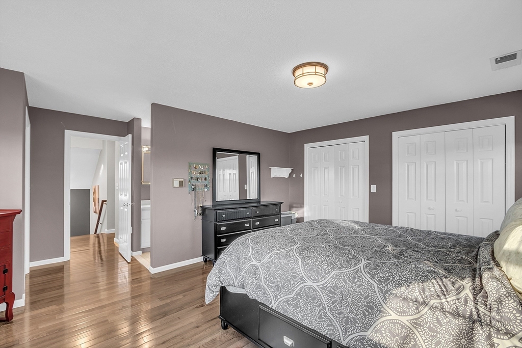 2 Countryside Lane, Unit 1301 Salem, MA 01970 - Photo 12 of 37 a bedroom with a bed and wooden floor