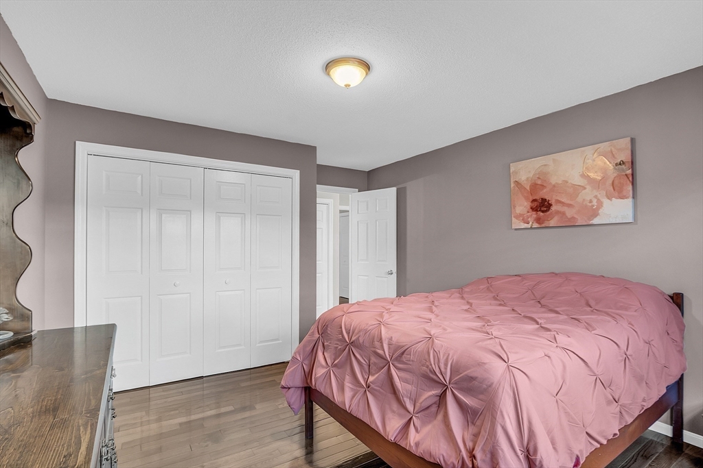 2 Countryside Lane, Unit 1301 Salem, MA 01970 - Photo 16 of 37 a bedroom with a bed and a painting on the wall