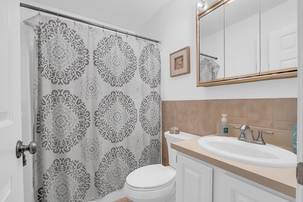 2 Countryside Lane, Unit 1301 Salem, MA 01970 - Photo 17 of 37 a bathroom with a sink toilet and a mirror