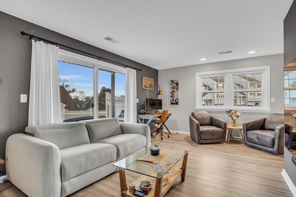 2 Countryside Lane, Unit 1301 Salem, MA 01970 - Photo 21 of 37 a living room with furniture and a large window