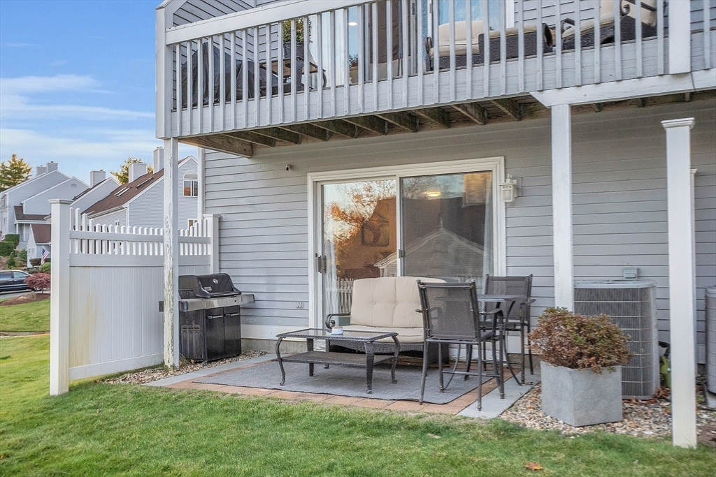 2 Countryside Lane, Unit 1301 Salem, MA 01970 - Photo 28 of 37 a view of a chair and table in patio with wooden fence