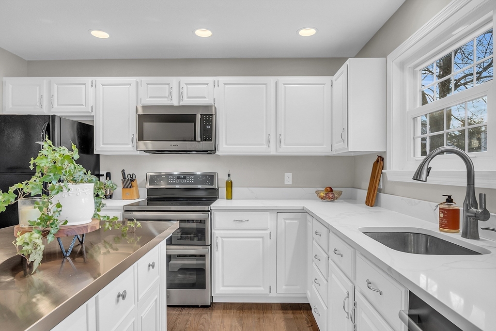 2 Countryside Lane, Unit 1301 Salem, MA 01970 - Photo 3 of 37 a kitchen with stainless steel appliances granite countertop grey cabinets a stove a sink and dishwasher