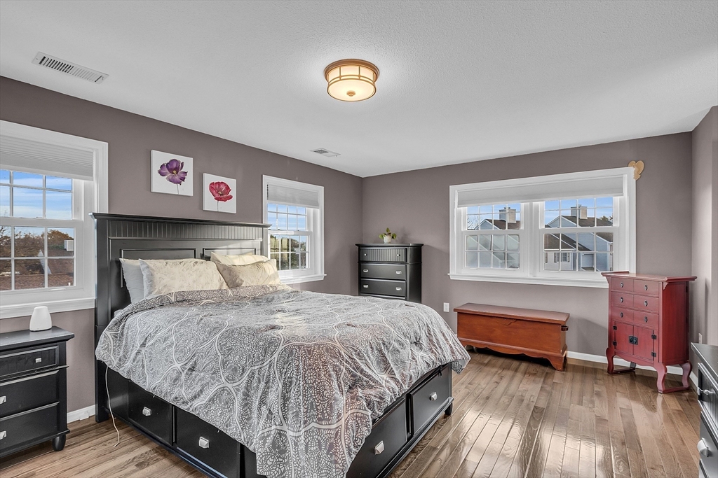 2 Countryside Lane, Unit 1301 Salem, MA 01970 - Photo 10 of 37 a bedroom with a bed and a chandelier