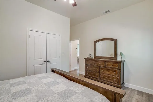 a bedroom with a bed and a dresser