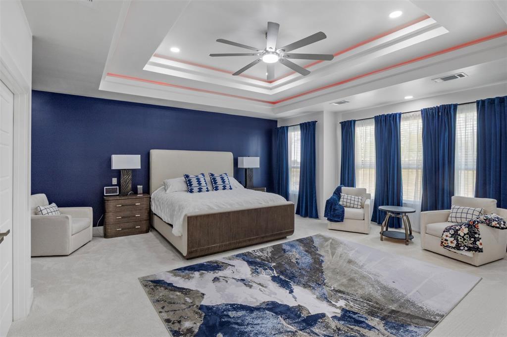 200 Corral Road Godley, TX 76044 - Photo 12 of 19 a bedroom with a large bed and a chandelier